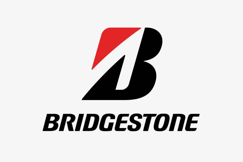 Production learners working on tyre manufacturing equipment at a Bridgestone production facility in Brits, South Africa.